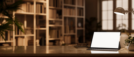 Modern stylish workspace close-up with tablet white screen mockup, wireless keyboard, table lamp, decor and copy space on tabletop over blurred library in background. 3d render, 3d illustrationの写真素材