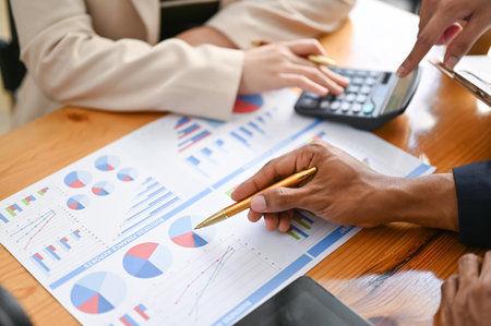 close-up hands image, Professional Asian male financial consultant or analyst working with his team,...