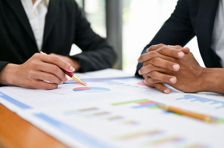 Serious and professional Asian businessman or male boss clenched fist, having a meeting with his financial team in the boardroom. cropped and close-up hand imageの写真素材
