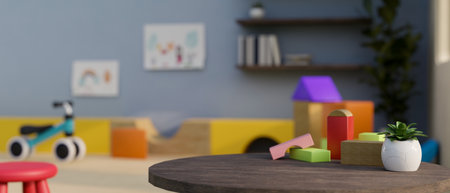 Copy space for product display on table with kid toys over blurred background of colorful kids...