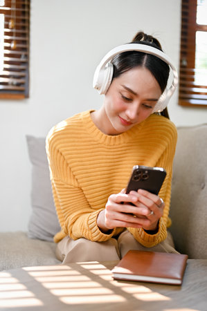 Portrait, Relaxed and chill millennial Asian woman in casual clothes wearing headphones, listening...