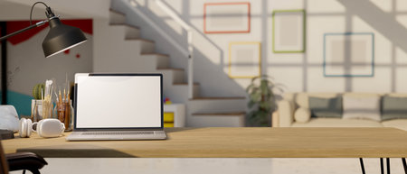 close-up, Workspace with laptop white screen mockup, headphones, painting tools, table lamp and copy space on wood tabletop over blurred background of minimal living room. 3d render, 3d illustrationの写真素材