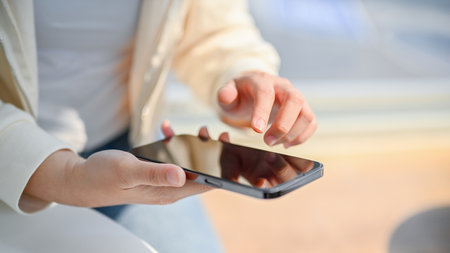 Close-up image of an Asian woman using her smartphone. chatting with friends, using mobile...
