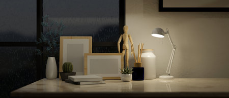 Close-up image of home decor on a table, blank frame mockup, book, table lamp, wooden figure and decor against the wall. 3d render, 3d illustrationの写真素材