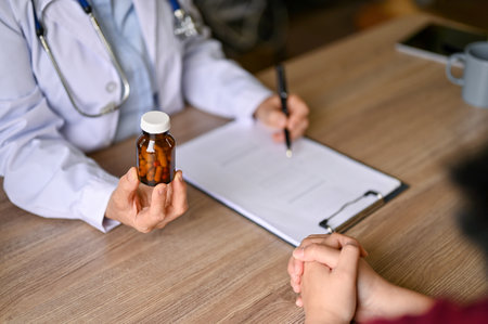 Close-up image of a professional female doctor explaining and giving medicine instructions to a patient during the medical appointment at a hospital.の写真素材