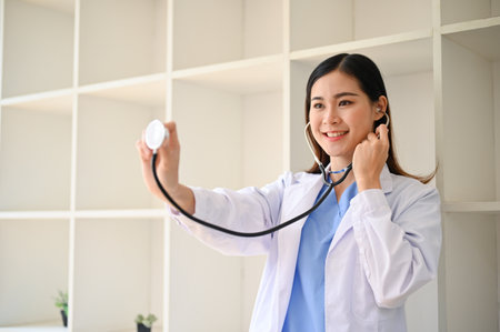 Attractive and beautiful young Asian female doctor in white gown with a stethoscope. Health care and medical conceptの写真素材
