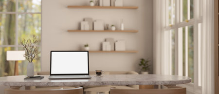 Home workspace with laptop white screen mockup and accessories on a marble dining table in minimal cozy dining room. 3d render, 3d illustrationの写真素材