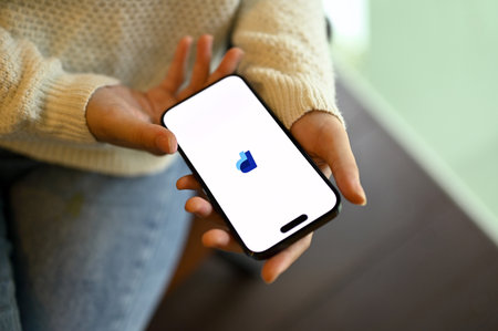 Chiang Mai, Thailand - May 15 2023: Top view of a woman holding her smartphone with PayPal logo banner on screen. iPhone with PayPal logoのeditorial素材