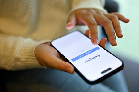 Chiang Mai, Thailand - May 15 2023: Close-up image of a woman login on her Instagram on her phone...