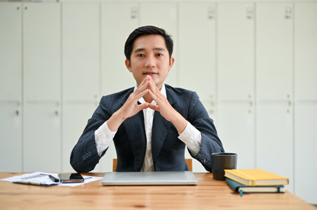 Professional and smart millennial Asian businessman sits at his office desk. Business people conceptの写真素材