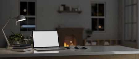 Home workspace with laptop computer white screen mockup with accessories on a tabletop in a cozy living room with fireplace at night. 3d render, 3d illustrationの写真素材