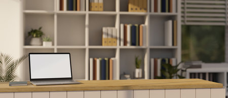 A portable laptop white screen mockup on a wooden countertop in a modern bookshop or library. 3d render, 3d illustrationの写真素材