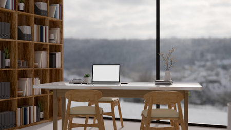 A laptop white screen mockup on a table by the large glass window in a modern luxury office room. 3d render, 3d illustrationの写真素材