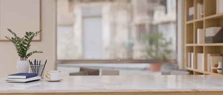 Close-up image of a luxury white marble tabletop with books, stationery, decor, and empty space...