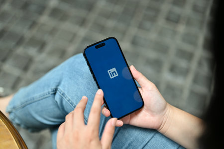 Chiang Mai, Thailand - Jul 11 2023: Close-up image of a female using LinkedIn application while...