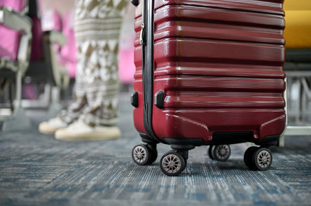 Close-up image of a red luggage on a plane aisle. journey, trip, vacation, transportation, airplaneの写真素材