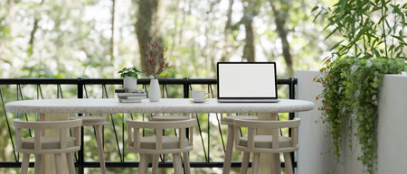 A laptop white screen mockup on a minimal white table on a balcony with a beautiful nature view. 3d...