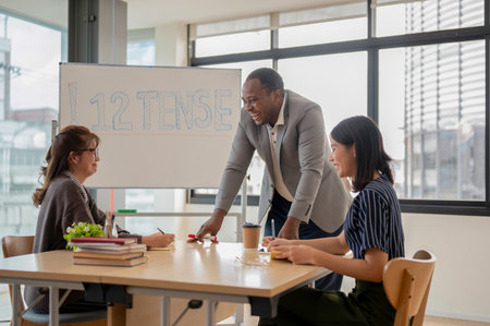 A professional and cheerful African American male English teacher or tutor is laughing and enjoying...
