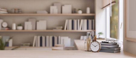Close-up image of a wooden tabletop with copy space, an alarm clock, books, and painting tools over...
