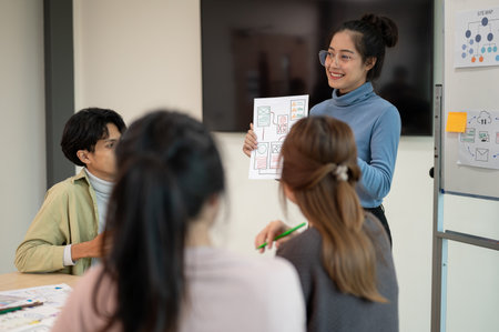 Young smart UX UI designer presenting her idea to the team, presentation during the team meeting. UX UI conceptの写真素材
