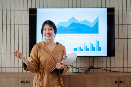 A confident and professional Asian businesswoman or female financial analyst is presenting her financial analysis information in the meeting.の写真素材