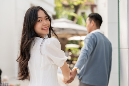 Portrait of young lovely adorable Asian couple spending time together, hugging and holding and holding hand. Couple conceptの写真素材