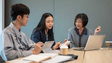 Group of diverse professional Asian businesspeople are in the meeting, consulting about a new financial project and planning strategies together.の写真素材