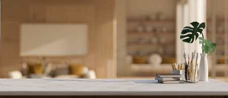 Close-up image of a creative workspace with books, painting tools, and empty mockup space on a...