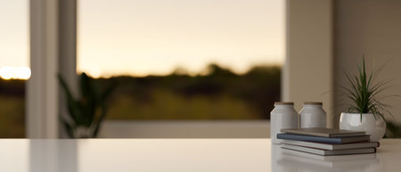 Empty mockup space for displaying your product on a tabletop with books and ceramic potted plant in a modern room. blurred background. 3d render, 3d illustrationの写真素材