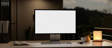 A modern dark private office at night with a white-screen computer mockup, a table lamp, and...