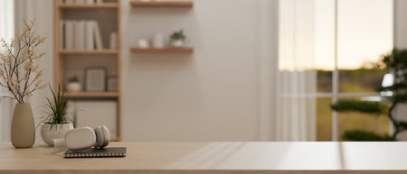Close-up image of a wooden table with a headphone, flower vases, a book, and a copy space to display your product in a modern minimalist white room. 3D render, 3D illustrationの写真素材