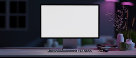 A modern home office with a white-screen computer mockup and accessories on a table in a modern dark living room with neon lights. 3d render, 3d illustrationの写真素材