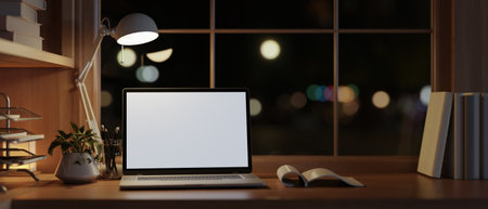 A modern and cozy home office workspace at night with a white-screen laptop computer, dim light from a table lamp, and accessories on a wooden table. 3d render, 3d illustrationの写真素材