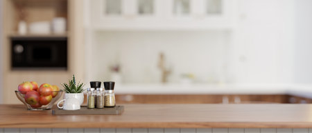 A close-up image of an apple bowl, spice bottles, a coffee cup, and a copy space on a wooden kitchen...