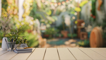 A wooden table with books, eyeglasses, stationery, decor plants, and space for display products against the blurred background of a beautiful tropical backyard garden. 3d render, 3d illustrationの写真素材