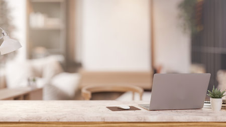 A laptop computer on a luxury white marble tabletop in a contemporary living room. close-up image of a workspace office desk. 3d render, 3d illustrationの写真素材