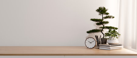 A front view of a minimalist wood tabletop with a clock, books, decor plants, and a space for display products against the white wall in a minimalist room. 3d render, 3d illustrationの写真素材