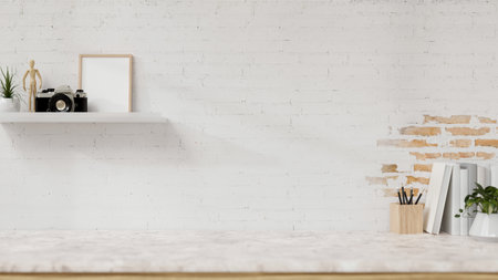 A display space on a white marble table showcases products, including books, stationery, a wall shelf, and a potted plant against the white brick wall. 3d render, 3d illustrationの写真素材
