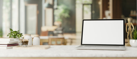 A white-screen laptop computer mockup, a coffee cup, and decor are on a table in a comfortable contemporary coffee shop co-working space. close-up image. 3d render, 3d illustrationの写真素材