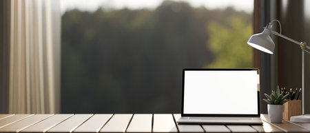 A laptop computer white-screen mockup and accessories on a wooden tabletop against the window with a nature view. workspace close-up image. 3d render, 3d illustrationの写真素材