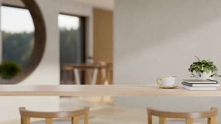 A close-up image of a wooden table in a cozy contemporary room with a coffee cup, books, a decor...
