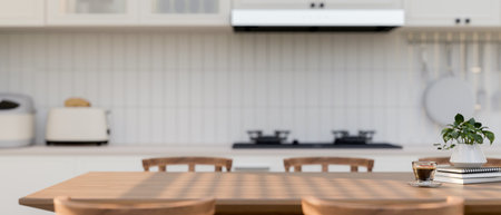 A space for displaying products on a wooden dining table in a contemporary white kitchen with...
