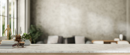 A close-up of a space for displaying products on a minimalist stone tabletop, featuring books and stationery, with a blurred background of a contemporary loft living room. 3d render, 3d illustrationの写真素材