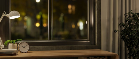 A close-up of a space for displaying products on a wooden table against the window in a cozy room at night, illuminated by a table lamp. 3d render, 3d illustrationの写真素材