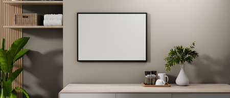 A blank picture frame mockup mounted on a grey wall in a contemporary room corner features...