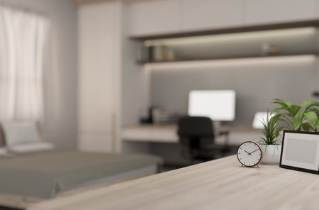 A close-up of a space on a wooden table with a blurred background of a contemporary bedroom with a workspace. 3d render, 3d illustrationの写真素材
