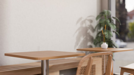 A space for displaying products on a wooden tabletop in a minimalist Japandi coffee shop features wooden table and chairs by the window, a white wall, and an indoor plant. 3d render, 3d illustrationの写真素材