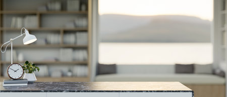 A close-up of a black marble desk with copy space for product display, featuring books, an alarm, a decorative plant, and a table lamp, set in a cozy living room or office. 3d render, 3d illustrationの写真素材