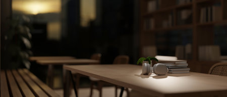 A close-up of headphones and stack of books on a wooden table in a comfortable minimalist library at...
