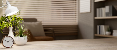 A close-up of a space on a wooden tabletop in a contemporary cozy room with armchair by the window, a bookshelf, and decor. 3d render, 3d illustrationの写真素材